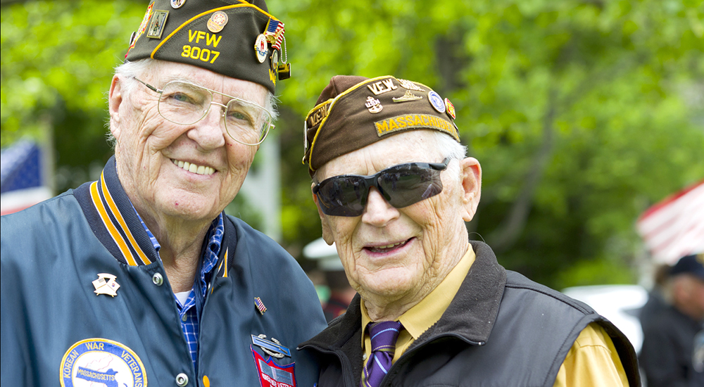 Two smiling senior Veterans in VSO caps, Parkinson's