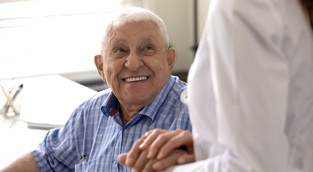 Senior man with dementia talks with member of BRO team