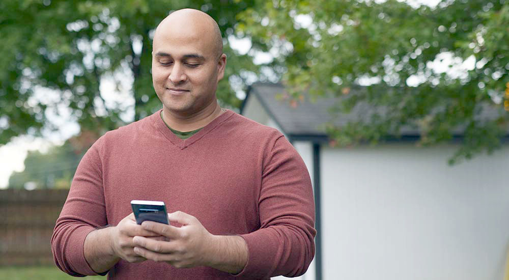 Man reading his phone; VCL; Veterans Crisis Line