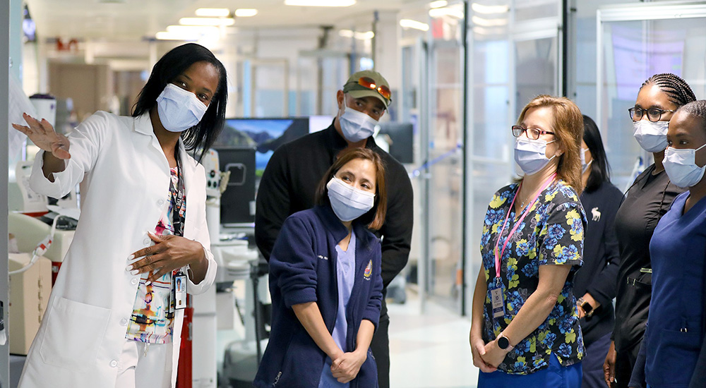 Nurse explaining wall display to a small group