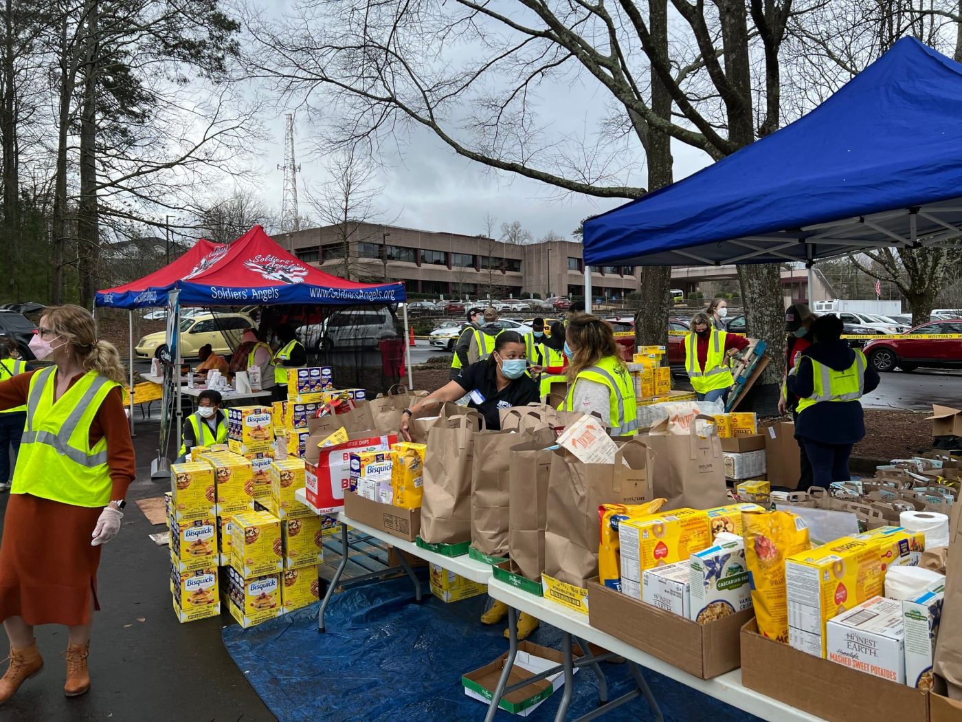 volunteers distribute food assistance to Veterans