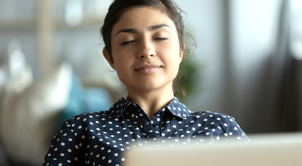 Woman closes eyes to find tranquility