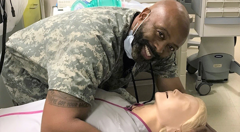 VA nurse hugging CPR mannequin