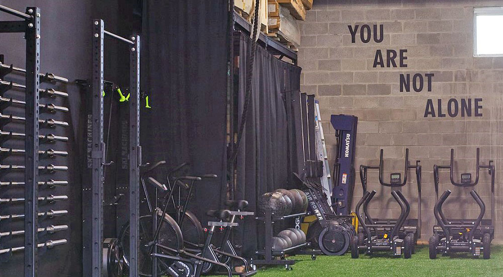 Fitness center with writing above exercise equipment