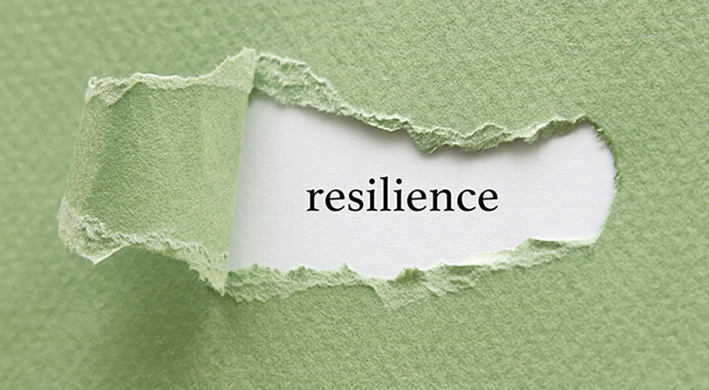 Resilience message written under torn paper.