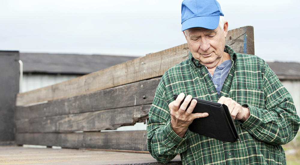 Rural Veteran reading his laptop despite digital divide