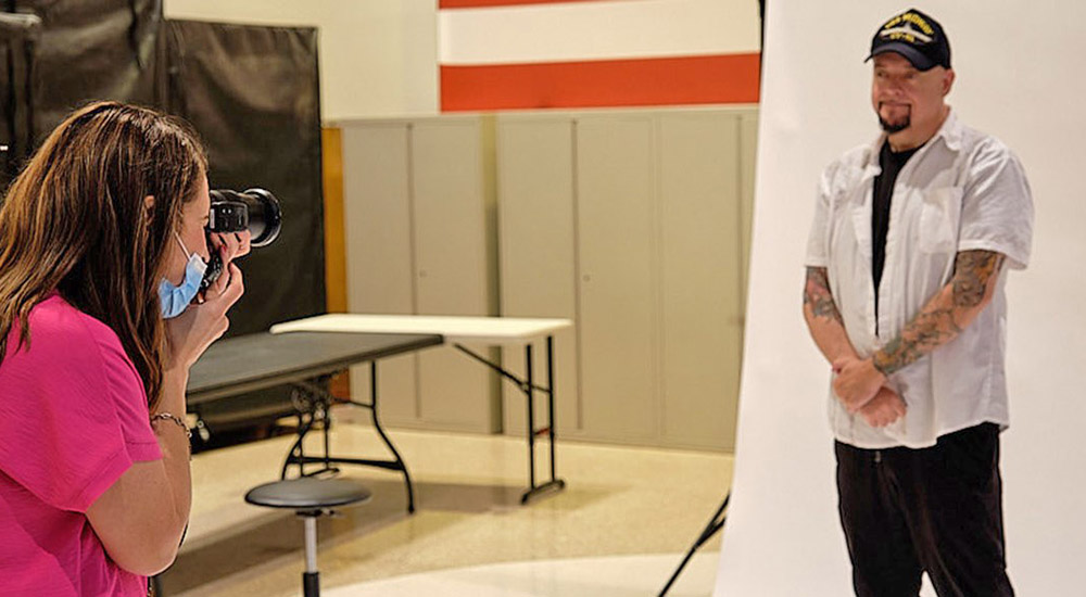 Photographer taking Faces of Service picture of Veteran