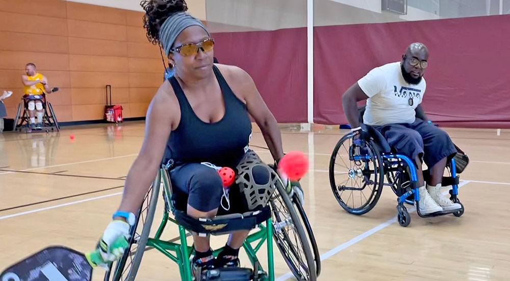 Woman in wheelchair playing pickleball
