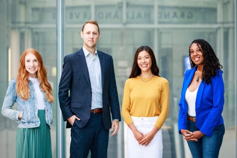 group of three young women and one young man in business attire representing Salesforce