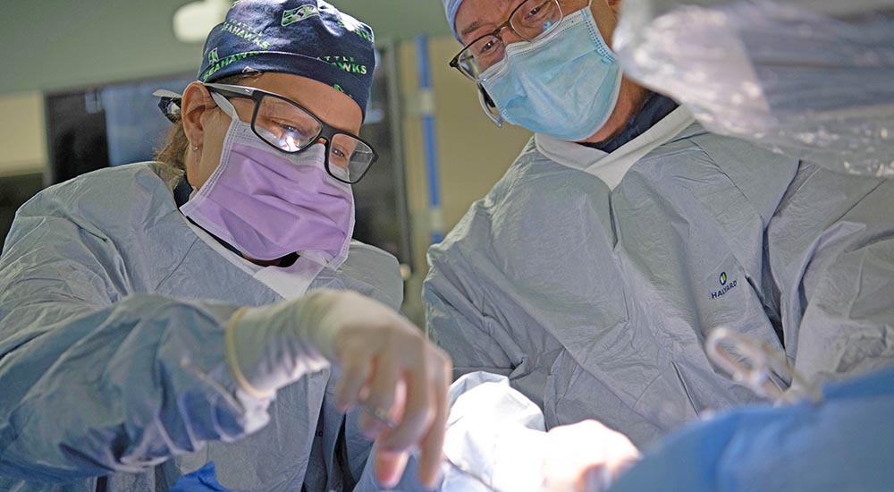 Doctors in OR performing TAVR procedure