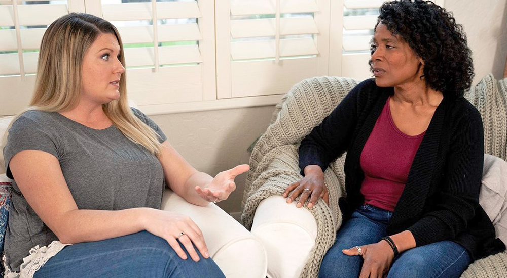 Woman counselor talking to another woman about drinking