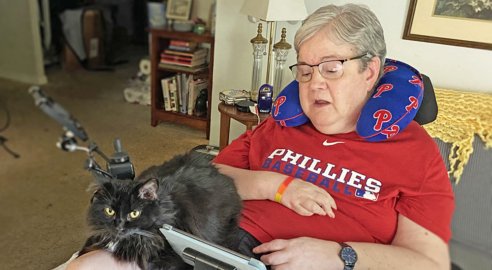 Housebound woman with an iPad and her cat