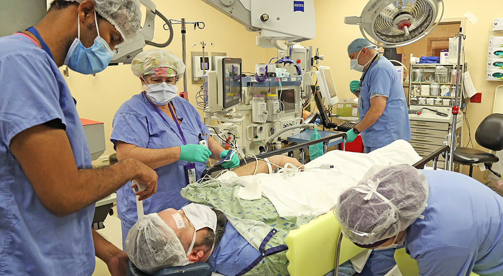 Staff and trainees train in a simulation operating room