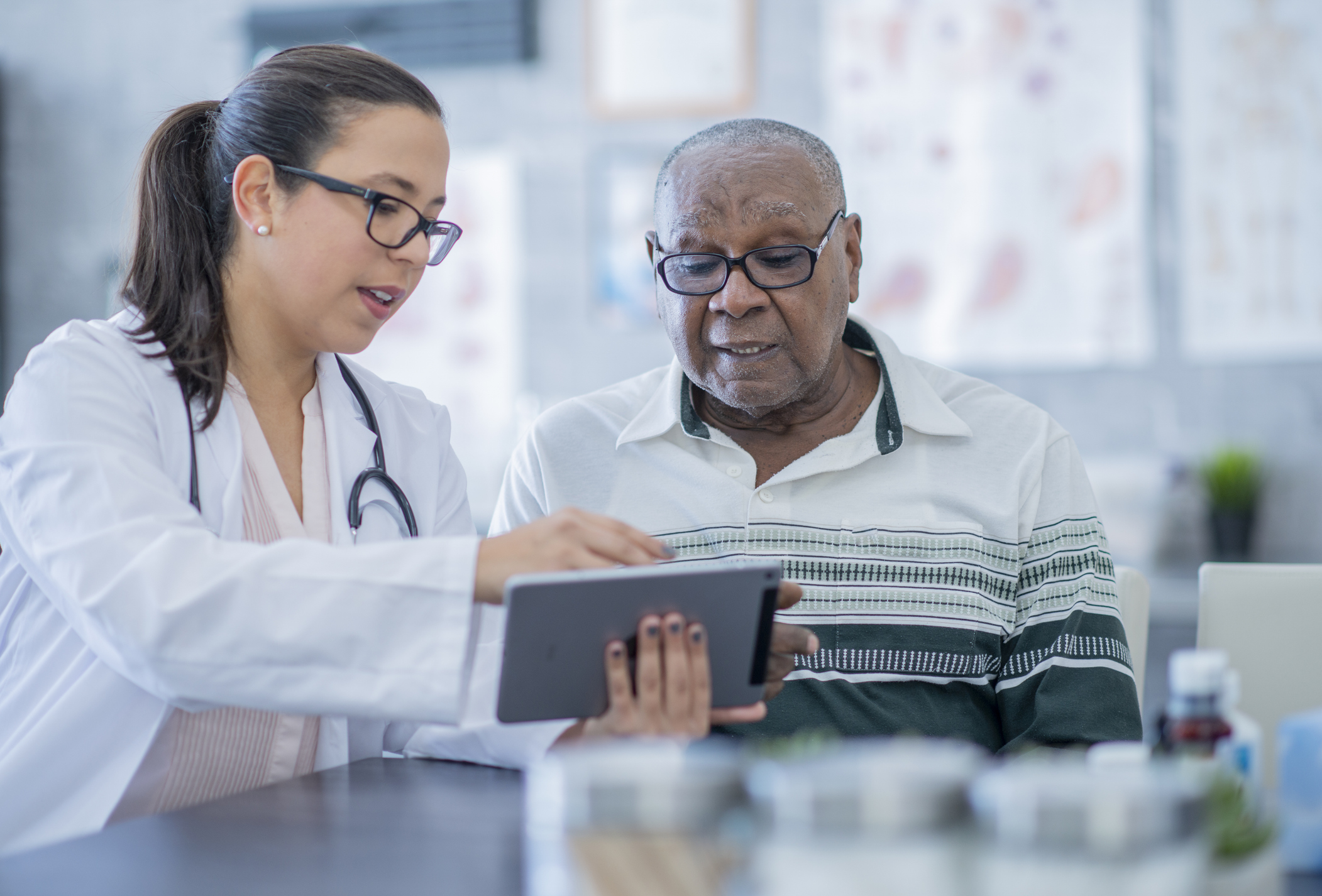 Man discussing health care with his doctor.