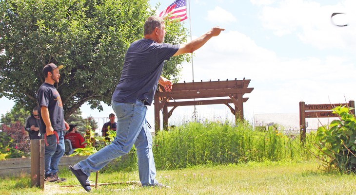 Man throwing horseshoe