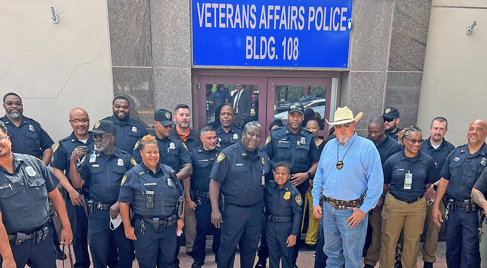 Large group of police officers with small boy