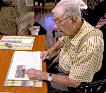 Senior Veteran points to image of his WWII ship