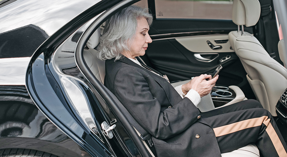 Women in car on phone for virtual mental health appointment