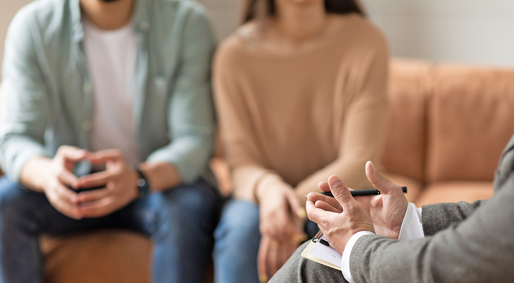 Two people listening to chaplain