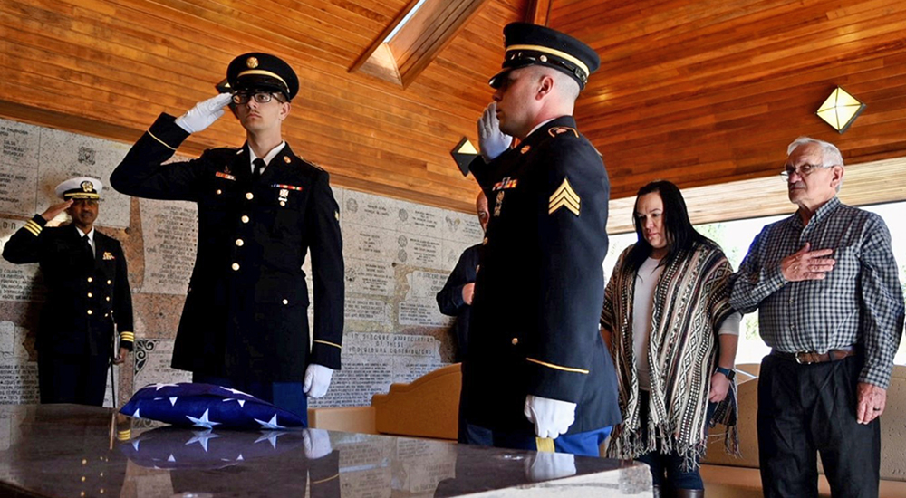 Family and honor guard at memorial ceremony; lost at sea