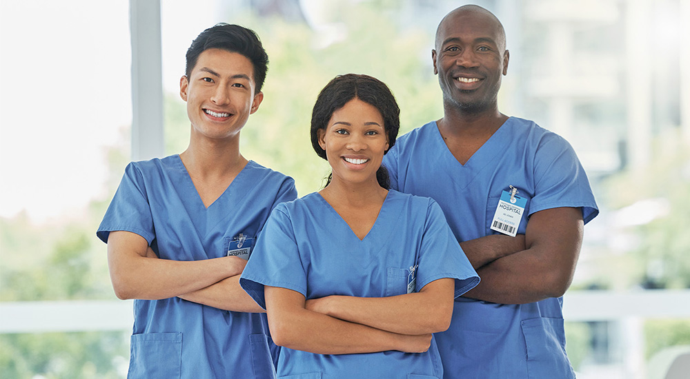 Three nurses in scrubs; practitioners