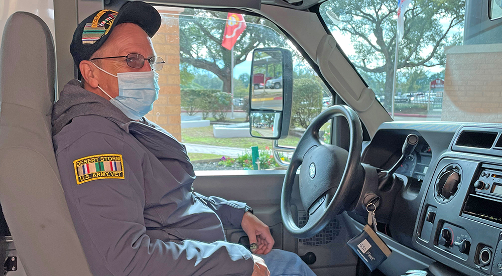 Shuttle bus driver in driver’s seat at Surge event