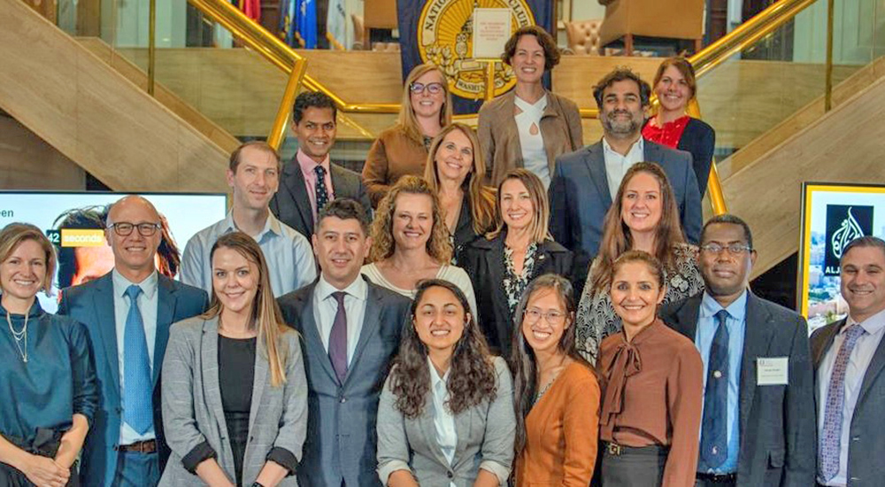 Large group of innovation fellows on stairs