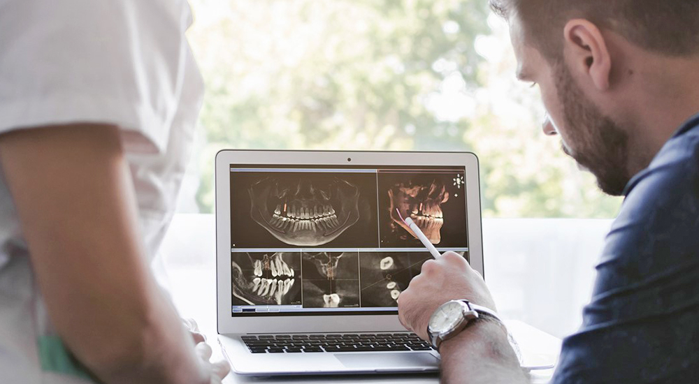 Man reading computer screen; advance surgical tool