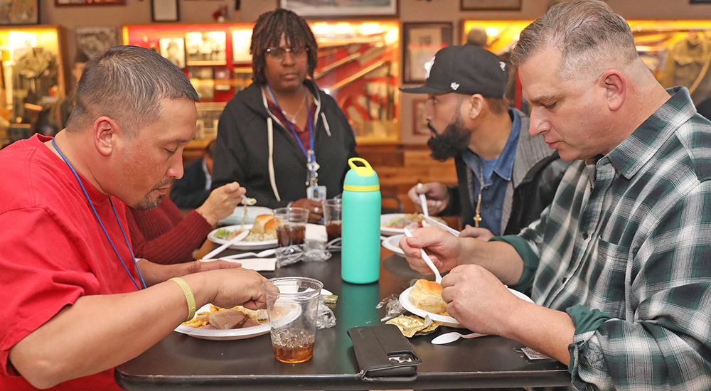 Several men enjoying Thanksgiving Day lunch hosted by Marines, VFW