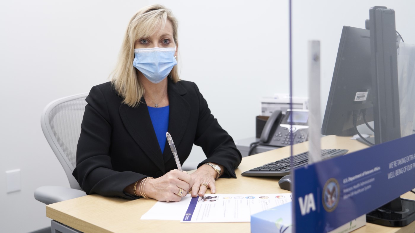 A human resources manager works at her desk in a VA facility.