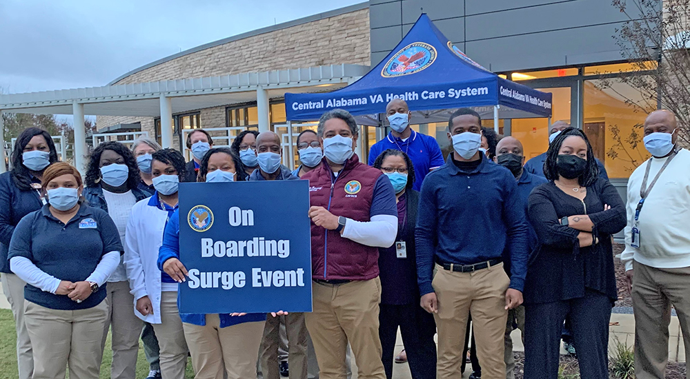 Large group in front of VA medical center; onboarding