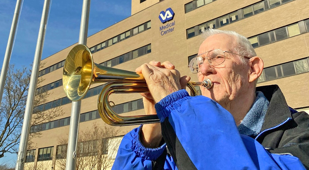 Senior Veteran playing Taps on bugle