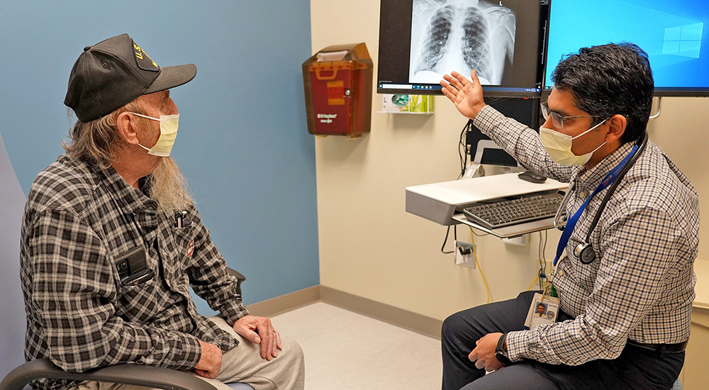 Doctor and patient view x-rays; emphysema