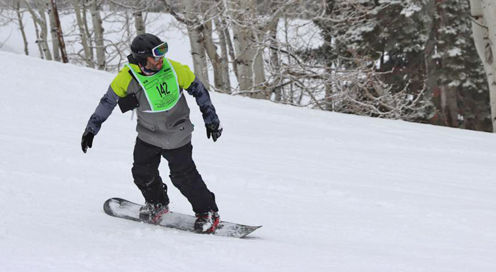 Man snowboarding on mountain snow; winter sports