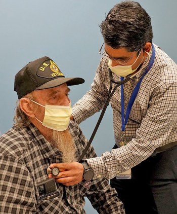 Doctor listens to patient’s lungs