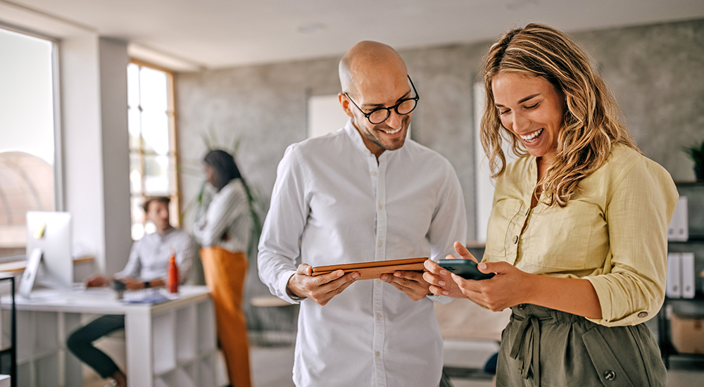 Man and woman read message devices