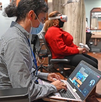 Veteran typing information into his laptop; virtual reality