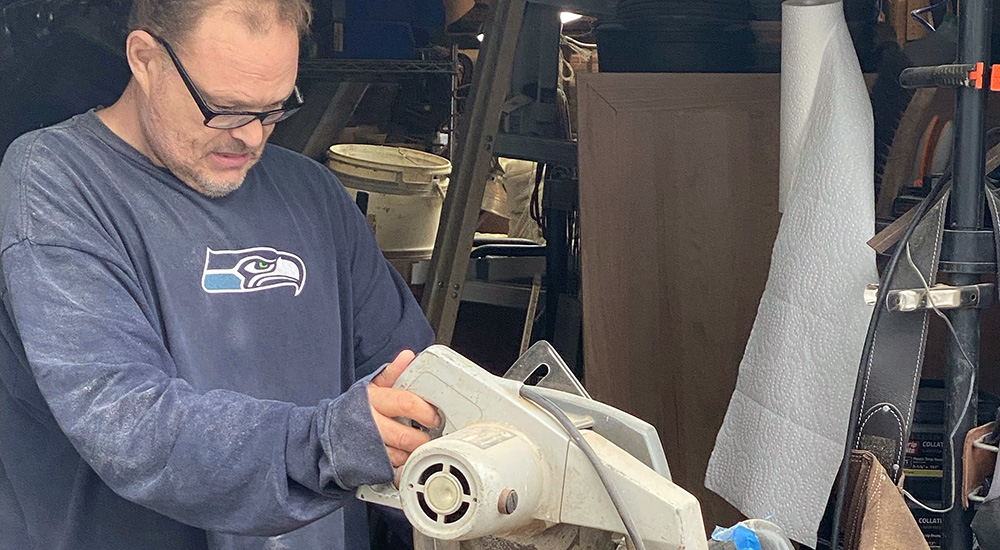 Man operating a table saw, acupuncture