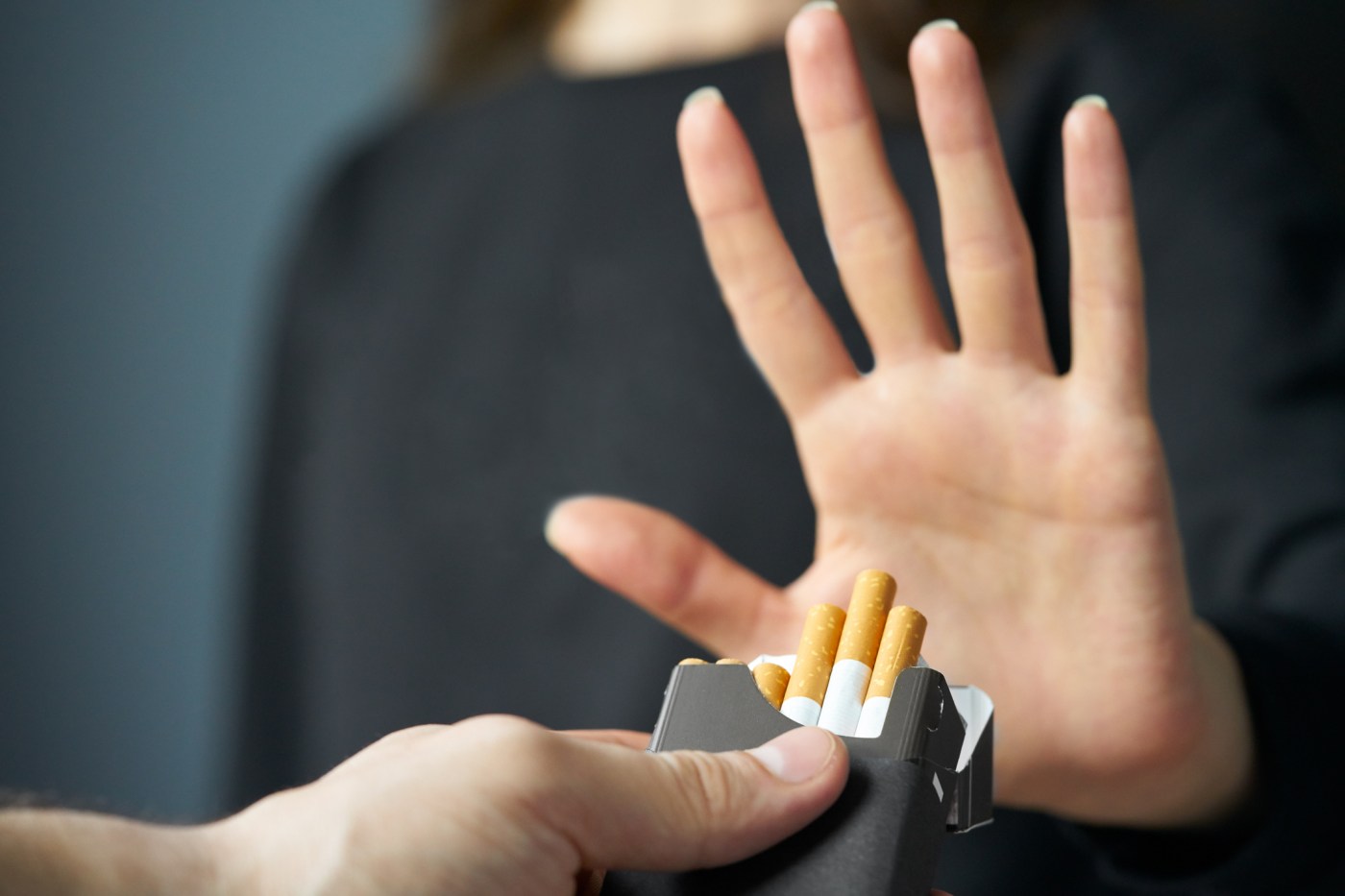 Handheld up gesturing no to cigarettes; Stay Quit coach