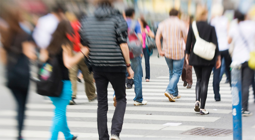 Hazy focus of large group walking; human trafficking