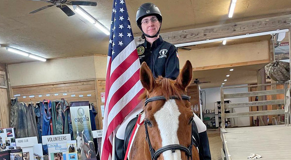 Woman Veteran riding a horse; equestrian therapy