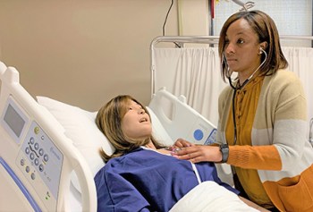 Nurse in simulation exercise with mannequin