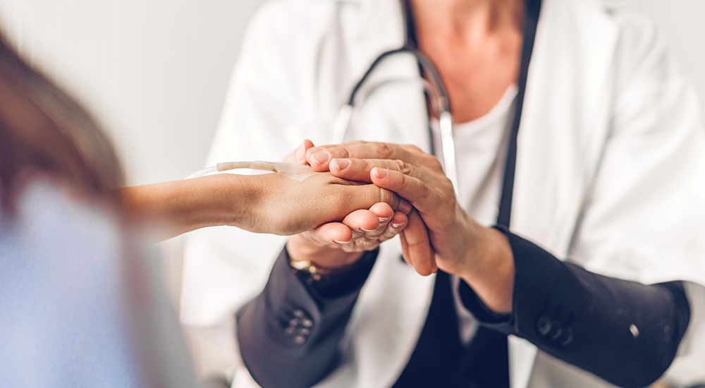 Photo of nurse practitioner holding someone's hand