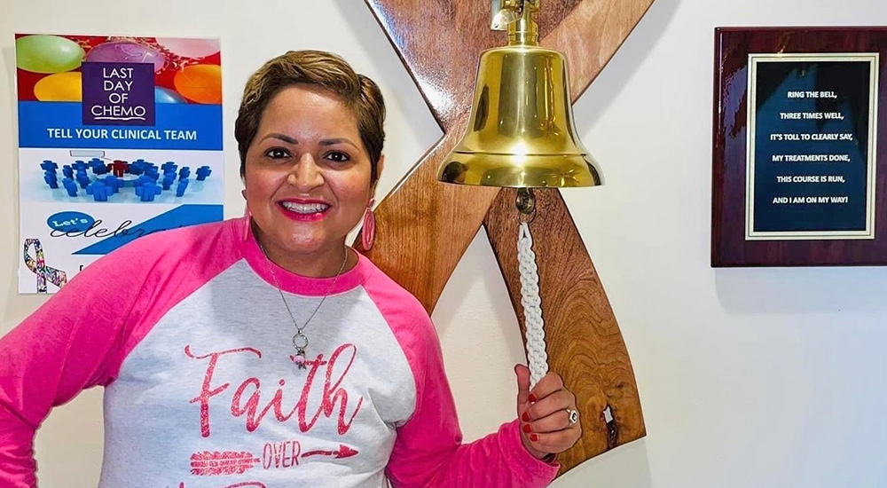 Woman rings bell in Cancer Center