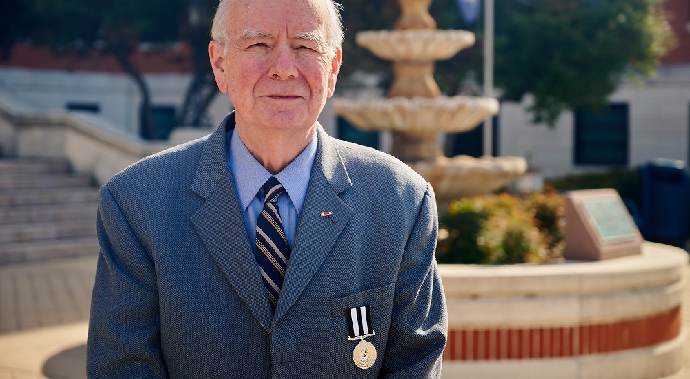 Senior VA volunteer wearing medal of a knight