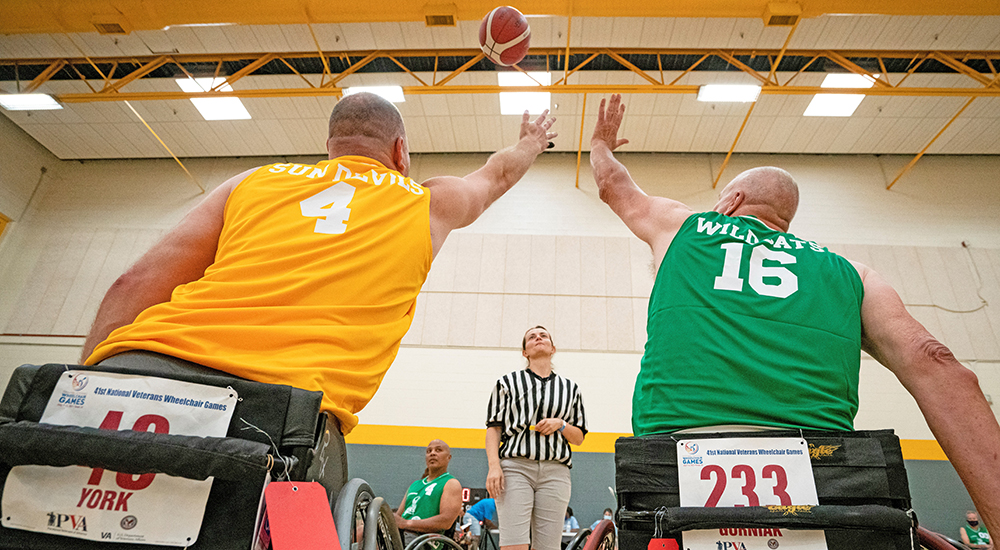 Jump ball between two men in wheelchairs