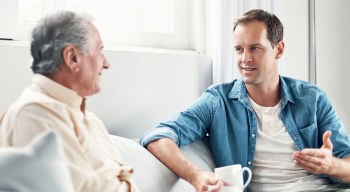 Young man visits with older man