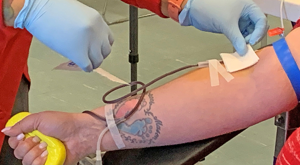 Person’s arm donating blood