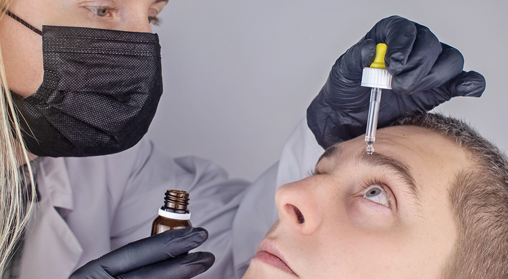 Man receives eye drop; pharmacist