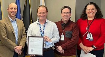 VA employee with award and three VA employees